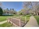 Bridge over a creek on a sunny day with green grass, trees and walking path leading to the community pool at 5950 Gunbarrel Ave # F, Boulder, CO 80301