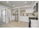 Well-lit kitchen featuring stainless steel appliances, white cabinets, and modern fixtures at 5950 Gunbarrel Ave # F, Boulder, CO 80301