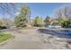 Exterior of parking area with a circular drive and nicely maintained landscaping and community buildings at 5950 Gunbarrel Ave # F, Boulder, CO 80301