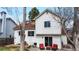 Backyard features a patio with furniture, mature trees, and sliding door access to the home at 3206 Columbine Ct, Broomfield, CO 80020