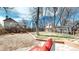 A spacious fenced backyard features a gravel area and mature trees in a desirable neighborhood at 3206 Columbine Ct, Broomfield, CO 80020