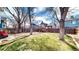 Large backyard with a wooden fence and mature trees at 3206 Columbine Ct, Broomfield, CO 80020