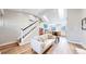 Cozy living room with skylights offers staircase views to the kitchen with bright natural light at 3206 Columbine Ct, Broomfield, CO 80020