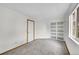 Bright bedroom features plush carpet, closet, and natural light from the window at 922 S Dearborn Way # 8, Aurora, CO 80012