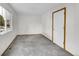 Empty bedroom with neutral carpet, closet and natural light coming in from the window at 922 S Dearborn Way # 8, Aurora, CO 80012