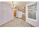 Bright dining area with modern lighting, neutral walls, and view into kitchen at 922 S Dearborn Way # 8, Aurora, CO 80012