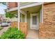 Exterior entrance featuring brick accents, a covered porch, and the door number 8 at 922 S Dearborn Way # 8, Aurora, CO 80012