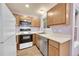 Efficient kitchen featuring stainless steel appliances, wood cabinetry, and bright lighting at 922 S Dearborn Way # 8, Aurora, CO 80012