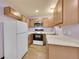 Efficient kitchen with white appliances, wood cabinets, and durable countertops at 922 S Dearborn Way # 8, Aurora, CO 80012