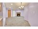 Open concept living room with fireplace and view to the kitchen with bright lighting at 922 S Dearborn Way # 8, Aurora, CO 80012