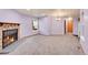 Spacious living room with a cozy fireplace, neutral carpet, and a large window at 922 S Dearborn Way # 8, Aurora, CO 80012
