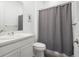 Well-lit bathroom featuring a vanity, toilet, and shower with gray curtain at 5681 Water Avens Dr, Castle Rock, CO 80104