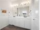 Bright bathroom featuring double vanity, stylish lighting, and modern fixtures at 5681 Water Avens Dr, Castle Rock, CO 80104