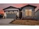Charming single-Gathering home featuring a two-car garage and tasteful stone and siding accents at 5681 Water Avens Dr, Castle Rock, CO 80104