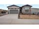 Well-maintained home with a two-car garage, manicured lawn, and inviting curb appeal at 5681 Water Avens Dr, Castle Rock, CO 80104