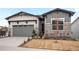 Beautifully designed home with stone accents, two-car garage, and drought resistant landscaping at 5681 Water Avens Dr, Castle Rock, CO 80104