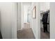 Hallway leading to the bathroom with a view into the walk in closet at 5681 Water Avens Dr, Castle Rock, CO 80104