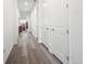 Long hallway with wood floors and doors at 5681 Water Avens Dr, Castle Rock, CO 80104