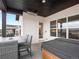 Covered outdoor patio with dining area, outdoor heater, and hot tub at 5681 Water Avens Dr, Castle Rock, CO 80104