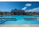 Community pool with clear blue water and relaxing lounge area in the background at 5681 Water Avens Dr, Castle Rock, CO 80104