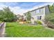 Large backyard featuring lush green grass and a multi-tiered deck with dining area at 5686 Brook Hollow Dr, Broomfield, CO 80020