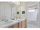 Bathroom featuring dual sinks, tile countertop, and a combined shower and bathtub at 5686 Brook Hollow Dr, Broomfield, CO 80020