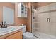 Cozy bathroom featuring a glass-enclosed shower and built-in shelving unit at 5686 Brook Hollow Dr, Broomfield, CO 80020