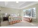 Inviting bedroom with tray ceiling, large window, and brass bed frame at 5686 Brook Hollow Dr, Broomfield, CO 80020