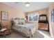 Cozy bedroom features a bed with floral bedding and a light-filled window at 5686 Brook Hollow Dr, Broomfield, CO 80020