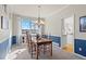 Bright dining room with large window and elegant chandelier lighting at 5686 Brook Hollow Dr, Broomfield, CO 80020
