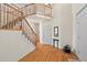 Grand foyer with soaring ceilings, hardwood floors, and an elegant staircase leading to the upper level at 5686 Brook Hollow Dr, Broomfield, CO 80020