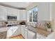 Well-lit kitchen with stainless steel appliances, white cabinets, granite counters, and a window overlooking the yard at 5686 Brook Hollow Dr, Broomfield, CO 80020