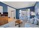 Cozy living room with blue walls, large windows, and stylish decor at 5686 Brook Hollow Dr, Broomfield, CO 80020