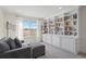 Bright living room featuring a built-in bookcase and comfortable seating at 5686 Brook Hollow Dr, Broomfield, CO 80020