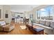 Open concept living room seamlessly flows into the kitchen, offering hardwood floors and abundant natural light at 5686 Brook Hollow Dr, Broomfield, CO 80020
