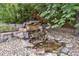 Picturesque rock and boulder water feature with stream and tranquil pond at 5686 Brook Hollow Dr, Broomfield, CO 80020