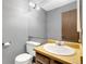 Cozy bathroom with a single sink, large mirror, and toilet, offering basic functionality and a tidy space at 1765 S Kline Way, Lakewood, CO 80232