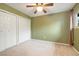 Vacant bedroom featuring neutral carpet and olive green paint at 1765 S Kline Way, Lakewood, CO 80232