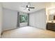Bright bedroom with a ceiling fan, neutral paint, and large closets at 1765 S Kline Way, Lakewood, CO 80232