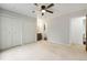 Spacious bedroom featuring a ceiling fan, double closets, and an ensuite bathroom, ensuring functionality at 1765 S Kline Way, Lakewood, CO 80232
