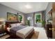 Cozy bedroom with neutral walls, large windows, and ample natural light at 1765 S Kline Way, Lakewood, CO 80232