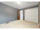 Simple bedroom featuring neutral paint and carpet and large closet doors at 1765 S Kline Way, Lakewood, CO 80232