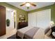 Bedroom showcasing olive walls, plush carpet, and a spacious closet at 1765 S Kline Way, Lakewood, CO 80232