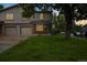 Traditional home featuring a well-manicured lawn and an attached two-car garage in a tranquil neighborhood at 1765 S Kline Way, Lakewood, CO 80232