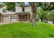 Traditional home featuring a well-manicured lawn and an attached two-car garage in a tranquil neighborhood at 1765 S Kline Way, Lakewood, CO 80232