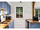 Well-lit kitchen features updated cabinets, butcher block counters, and stainless oven at 1765 S Kline Way, Lakewood, CO 80232