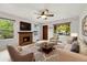 Inviting living room with a brick fireplace and large windows, offering ample natural light at 1765 S Kline Way, Lakewood, CO 80232