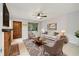 Cozy living room with a brick fireplace, comfortable seating, and a ceiling fan at 1765 S Kline Way, Lakewood, CO 80232