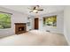 Bright living room featuring neutral paint and flooring and a cozy brick fireplace at 1765 S Kline Way, Lakewood, CO 80232