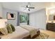 Serene main bedroom featuring a ceiling fan, large window, and double closets for ample storage at 1765 S Kline Way, Lakewood, CO 80232